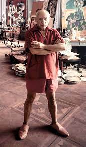 September 11, 1956, photo session in his Cannes studio, the artist dressed solely for comfort in a scarlet red terry cloth pullover with coordinated shorts and slip-on shoes.